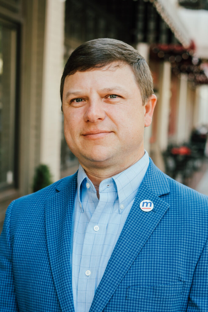 Brad Fuller, Executive Vice President for MartinFed's headshot, wearing a button-down shirt and blazer