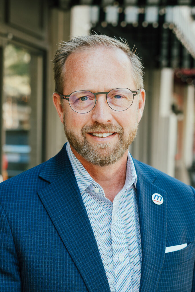 David Mathis, President & CEO of MartinFed's headshot, wearing a button-down shirt and blazer