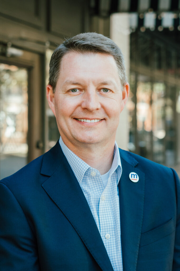 Jim Page, Executive Vice President of MartinFed's headshot, wearing a button-down shirt and blazer