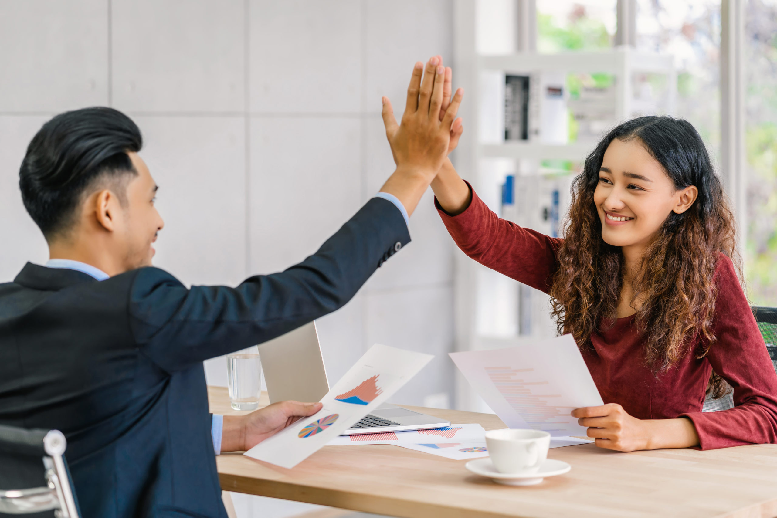 Coworkers giving each other a high five