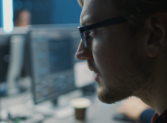 Man in glasses working at a computer